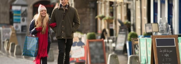 A young couple shop in the Grassmarket in Edinburgh, Scotland